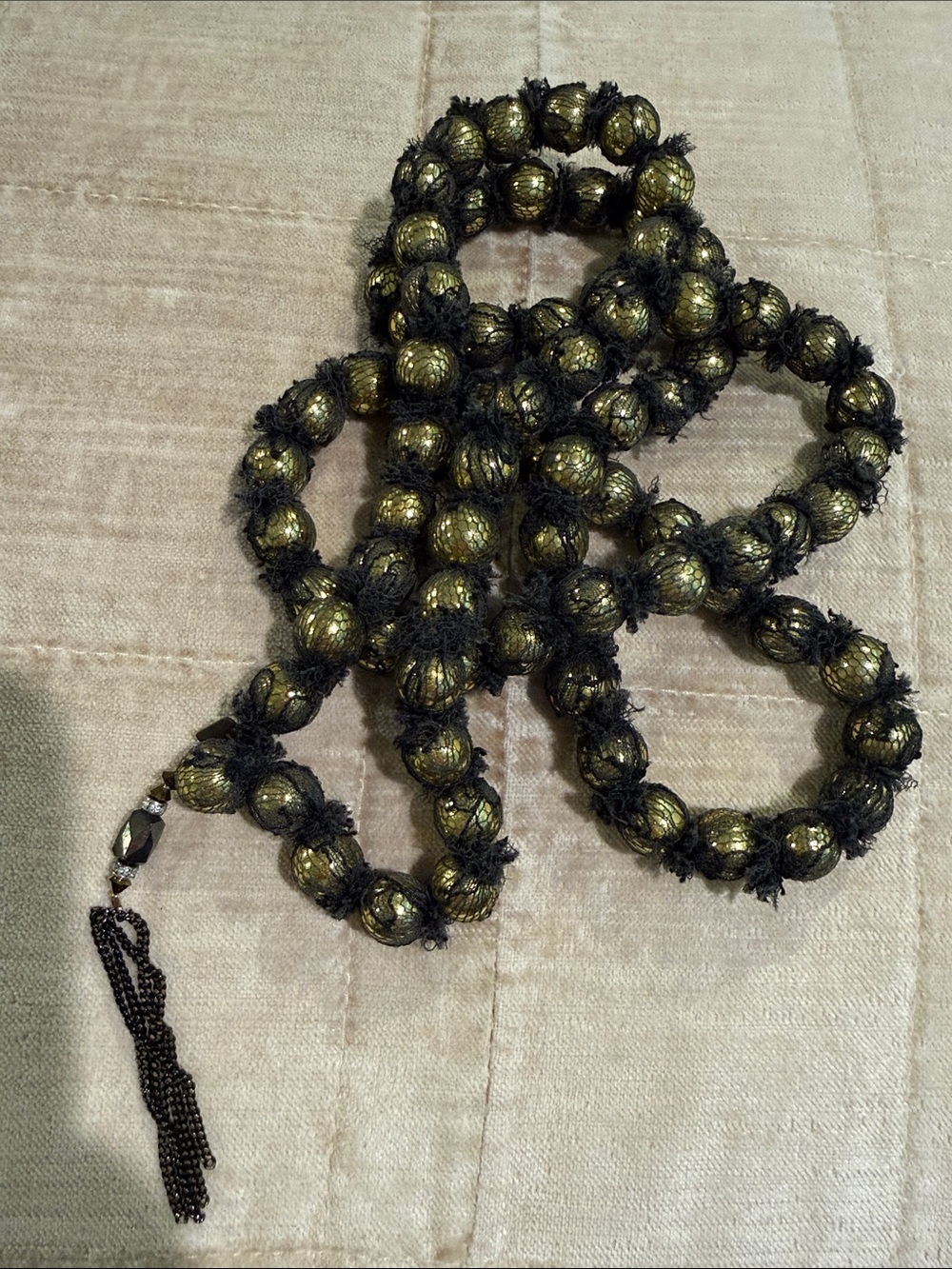 Marie Laure Chamorel tulle wrapped gold foil beads with tassel